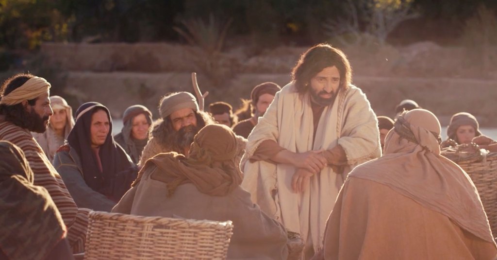 Jesus and the outcasts. Jesus sits together with a crowd of people
