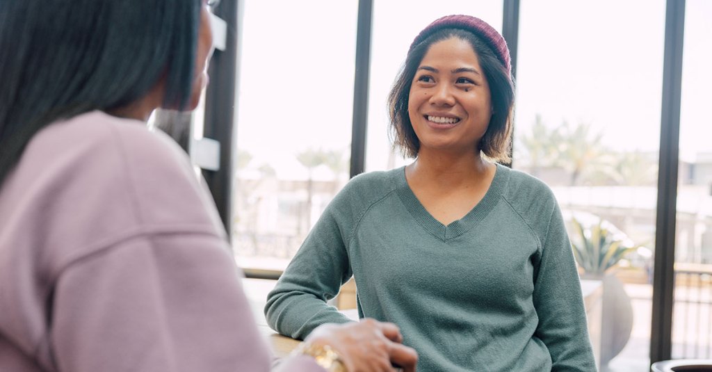 two woman talking at a church together
