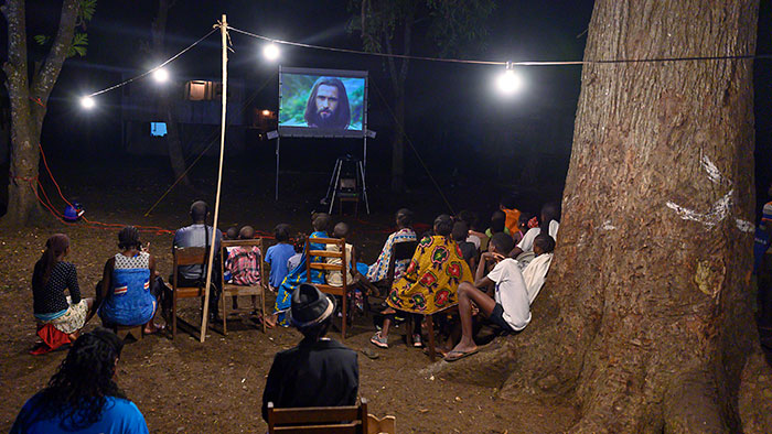 People sitting around a projector