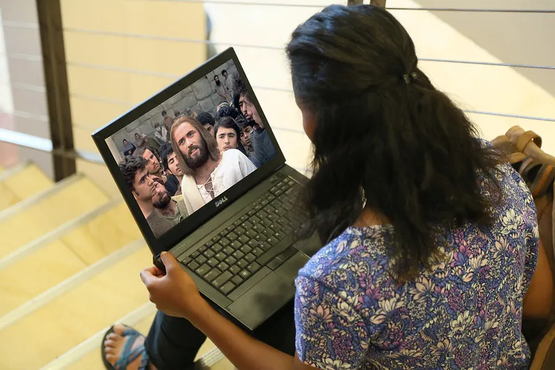 Woman watching the Jesus Film from her laptop 