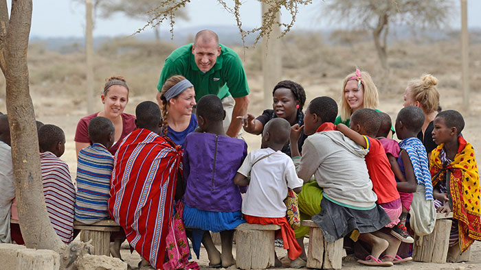 group of people sitting and talking in remote, african location