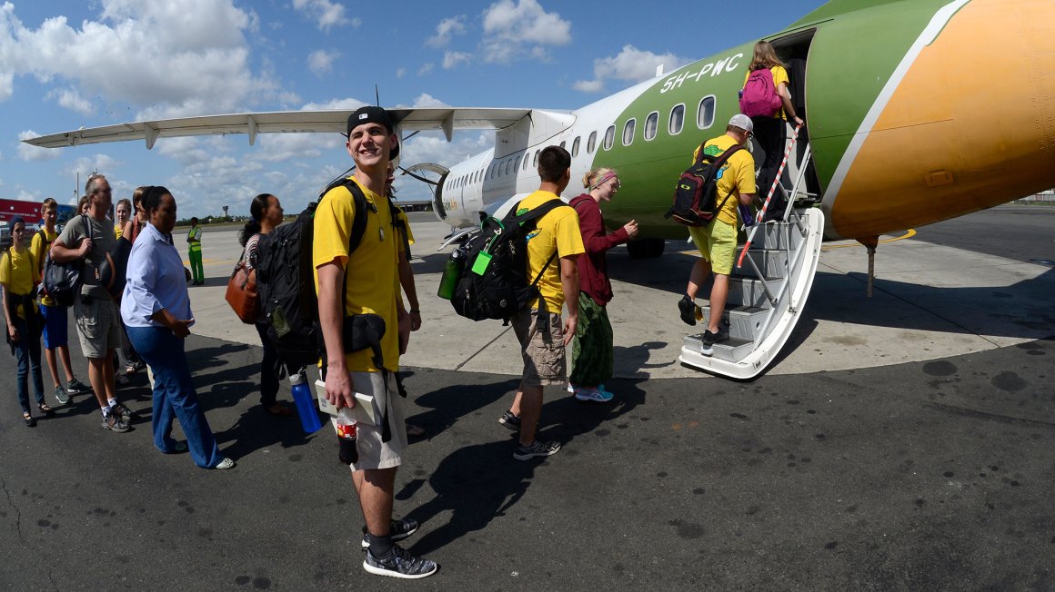 young kid waiting to board plane on tarmac