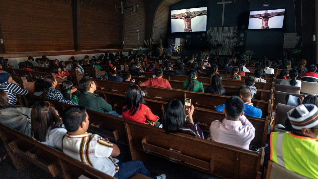 group watching the Jesus film in building