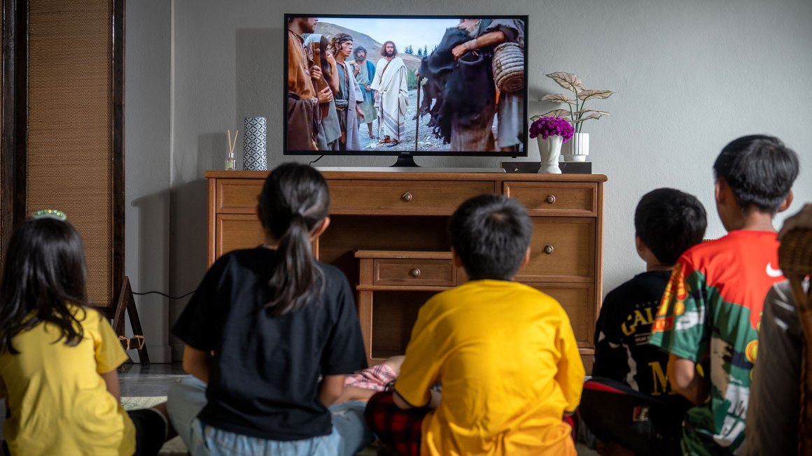 Children watching the Jesus Film on TV