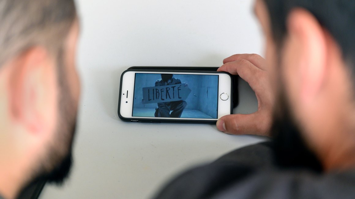 2 people watching a film on a cell phone