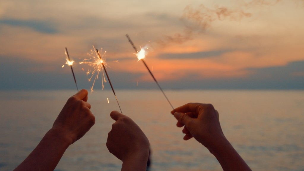 3 people holding sparklers