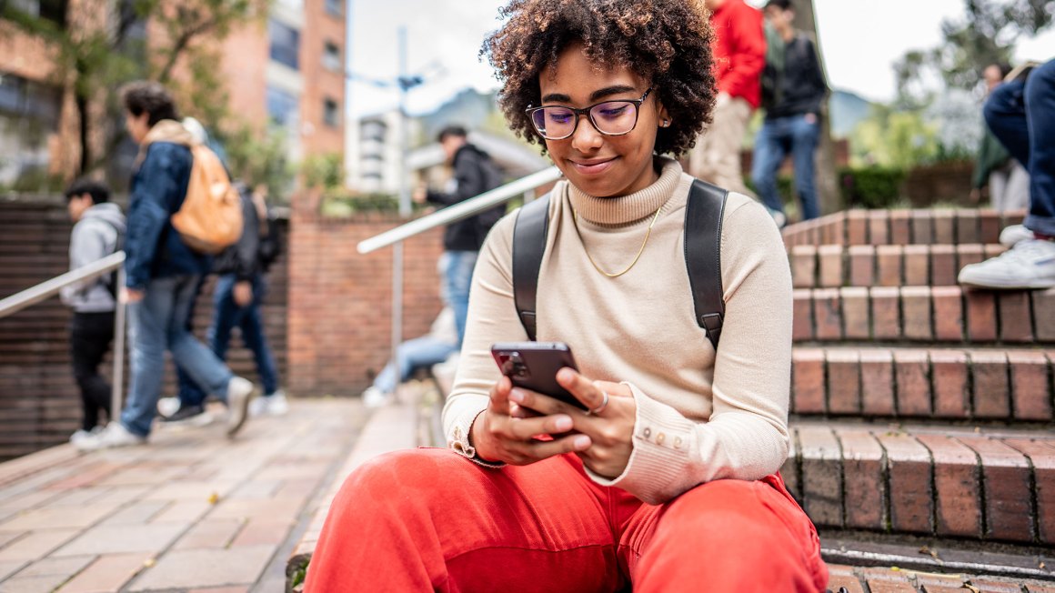 College aged woman looking at phone