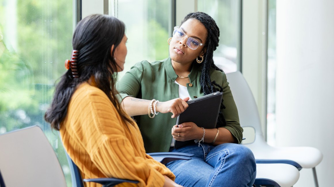 Two woman sitting and talking