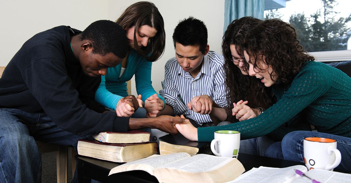 College aged friends having a bible study together