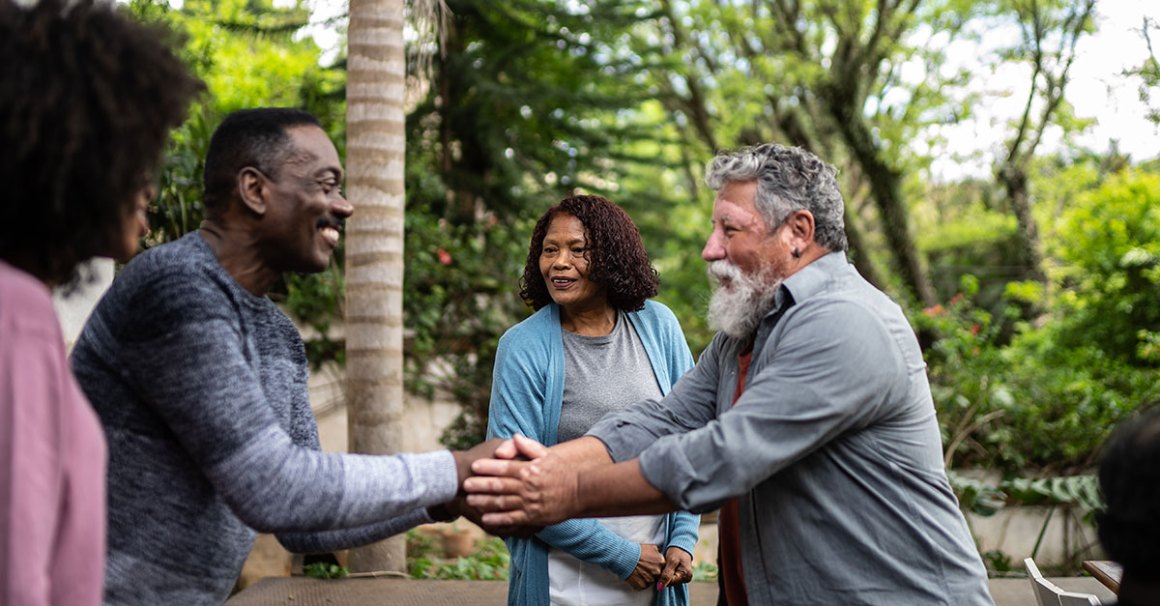 two men shaking hands outside