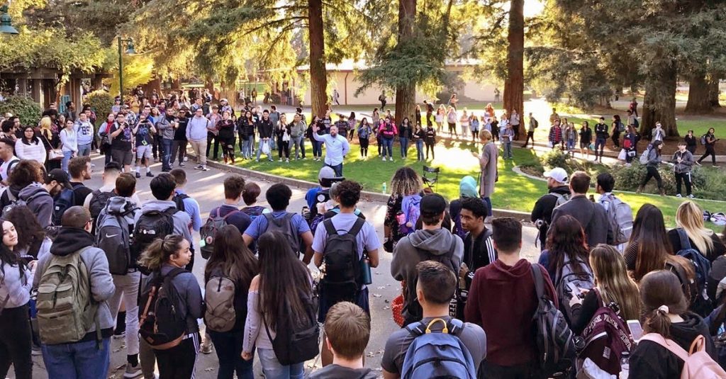 A man preaching in the middle of a crowd