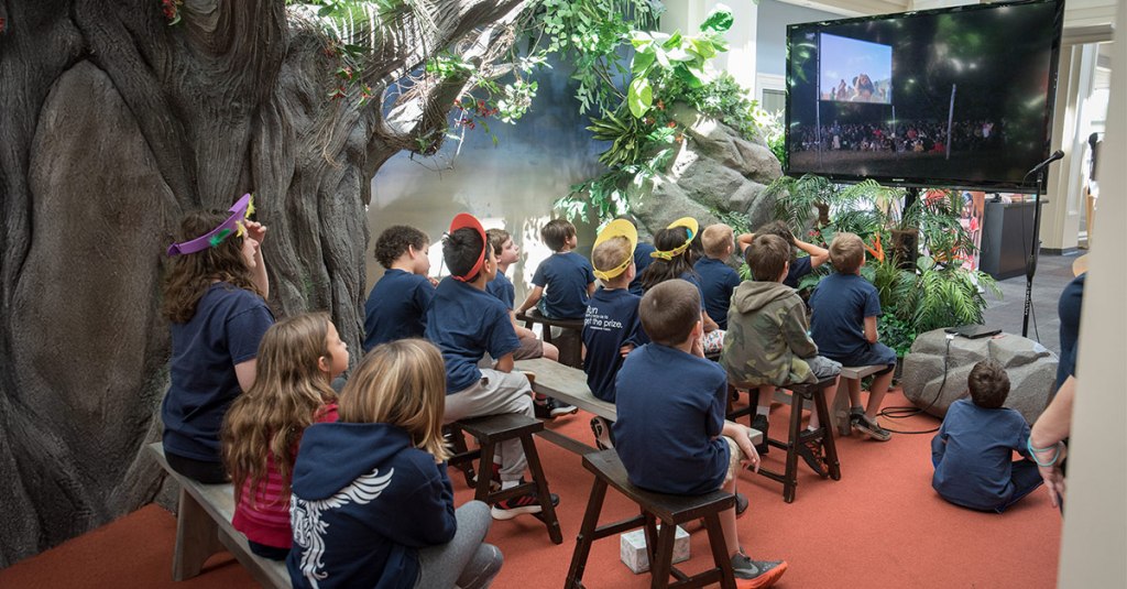 Kids watching a JESUS video as a vehicle for child and youth evangelism.