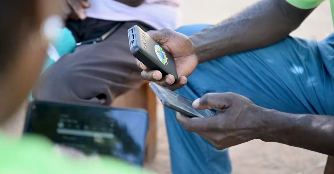 African man holding a cell phone