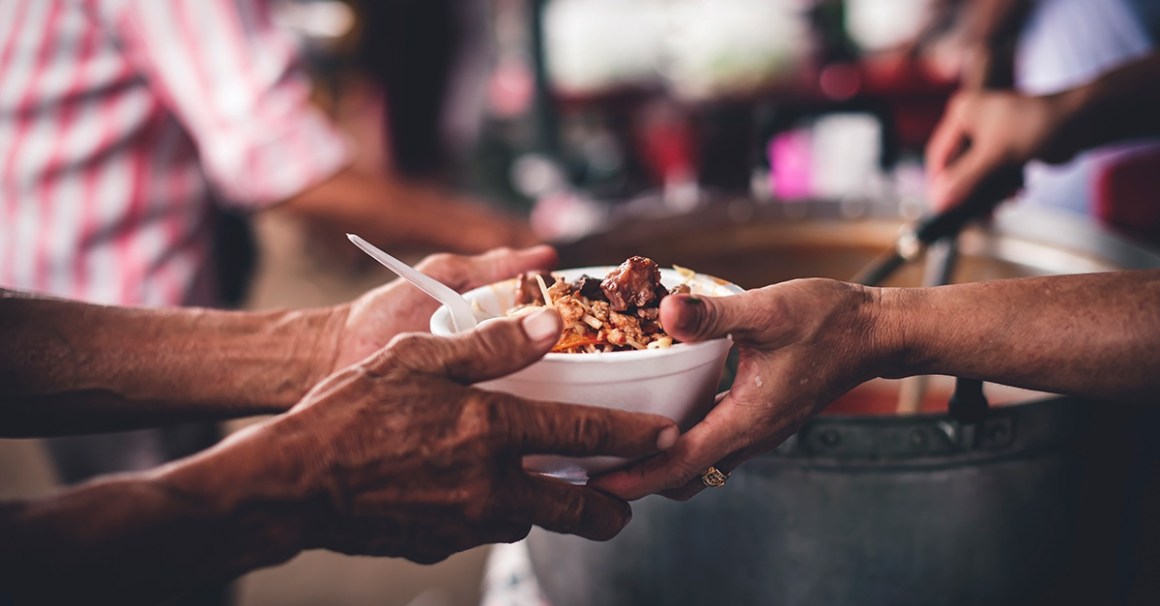 Image of food changing hands in food line